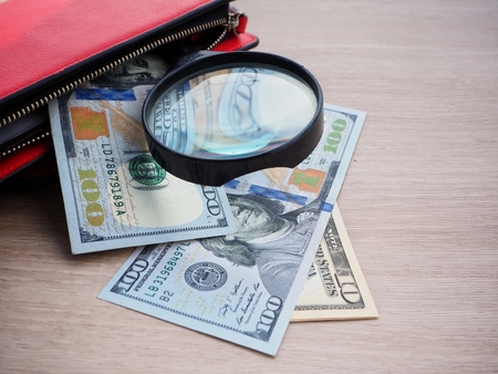 Magnifying glass with dollarsの写真素材