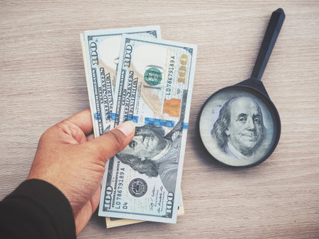 Magnifying glass with dollars
