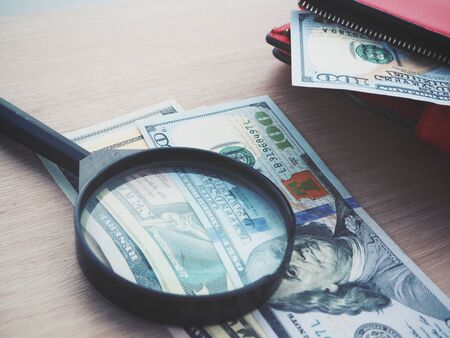 Magnifying glass with dollarsの写真素材