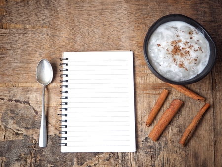 Rice pudding with blank notepadの写真素材