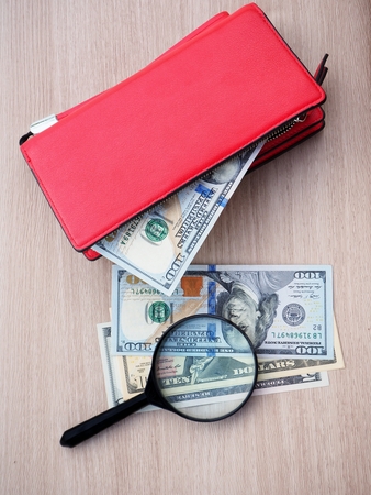 Magnifying glass with dollarsの写真素材