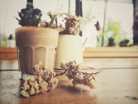 Coffee with milk and dried flowersの写真素材