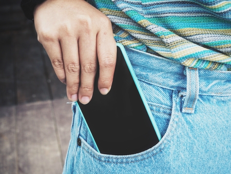 Smart phone in jeans pocketの写真素材