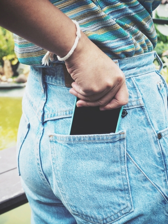 Smart phone in jeans pocketの写真素材
