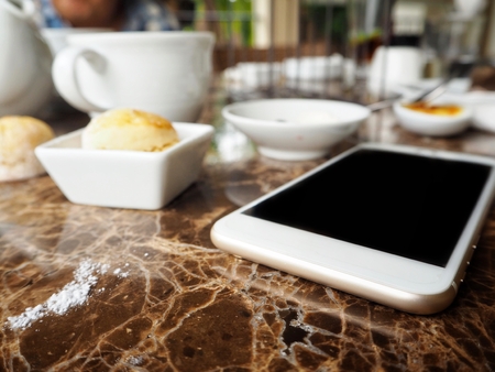 Smart phone with scones and english teaの写真素材