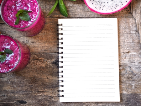 Dragon fruit smoothie with blank notepadの写真素材