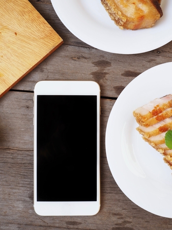 Smart phone with pork belly grilledの写真素材