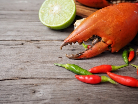 Crab claws close up with lime and chilliesの写真素材