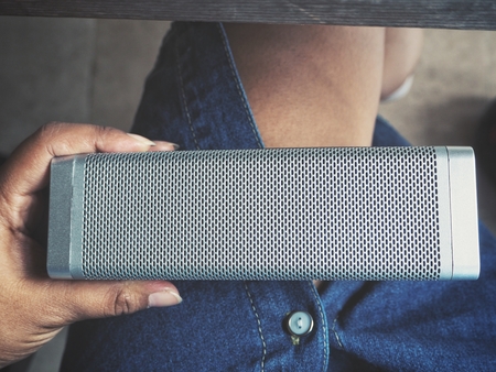 Woman using bluetooth speakerの写真素材