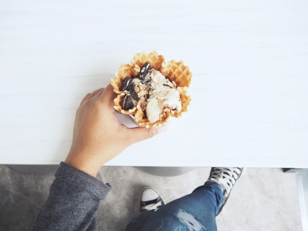 Woman eating ice cream coffeeの写真素材