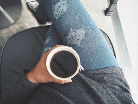 Selfie of coffee cup on handの写真素材