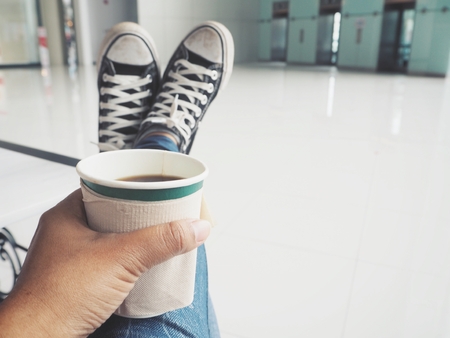 Selfie of coffee cup on handの写真素材
