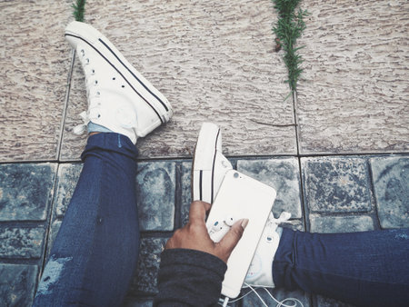 Selfie of smart phone and headphones with shoes
