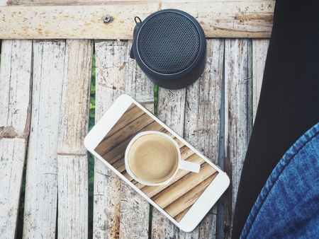 Taking a photo of coffee cup with smart phoneの写真素材