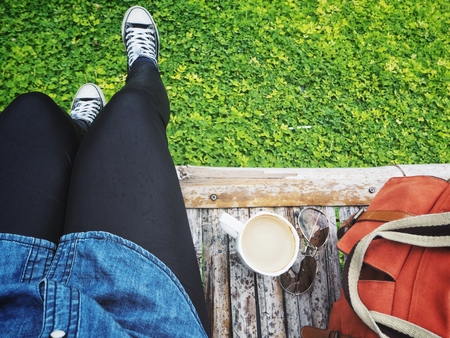 Woman drinking coffee with bagの写真素材
