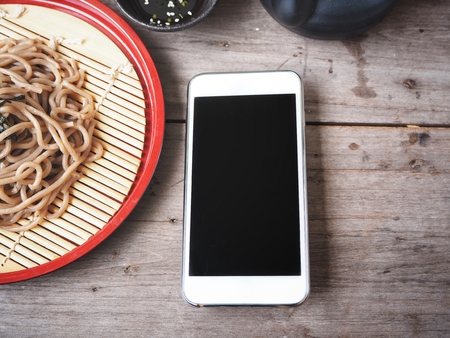 Smart phone with soba noodles Japanese foodの写真素材