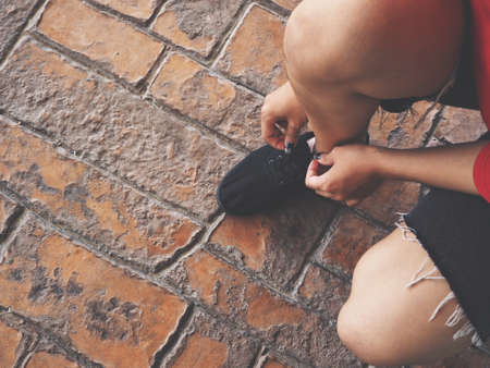 Woman tying running shoe lacesの写真素材