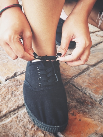 Woman tying running shoe lacesの写真素材