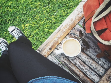Woman drinking coffee with bagの写真素材