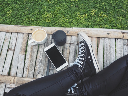 Selfei of bluetooth speaker with smart phone and shoesの写真素材