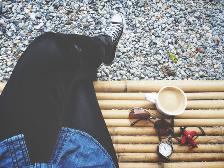 Woman with sunglasses with toy plane and coffee cupの写真素材