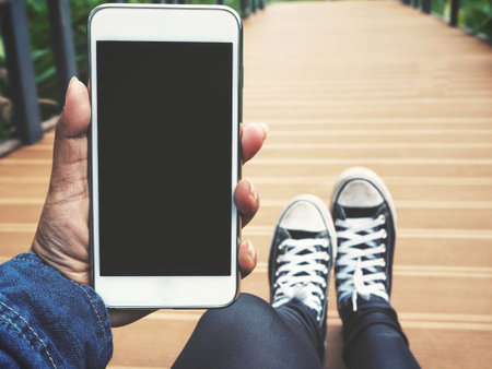 Selfei of smart phone on hand with bridge