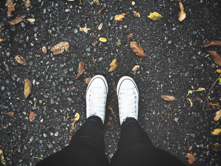 Selfie of sneakers with dried leaves
