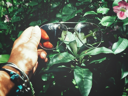 Sun glasses on handの写真素材