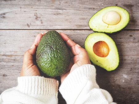 Avocado on handsの写真素材