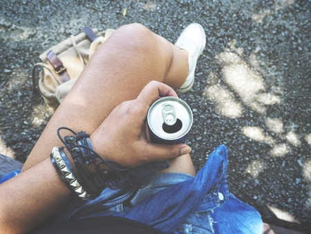 Woman drinking cola traveling with backpackの写真素材