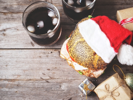 Hamburger and cola drink with christmas hatの写真素材
