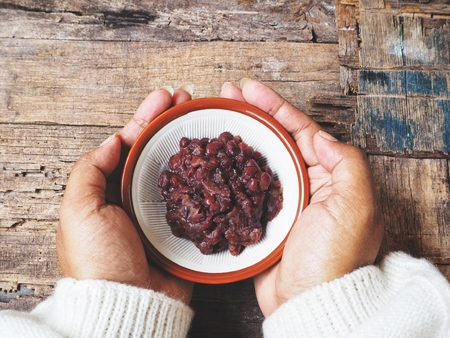Azuki red beans paste on handsの写真素材