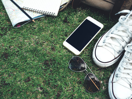 Travel accessories of bag with shoes and smart phone with sunglasses