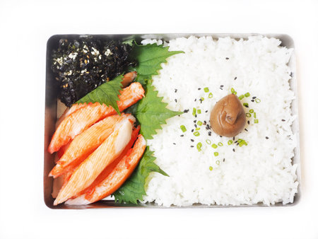 Japanese box of plum pickle on rice with seaweed and crab sticks
