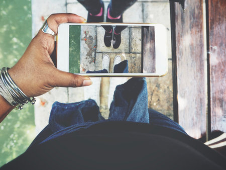 Taking a photo of friends shoes with smart phone
