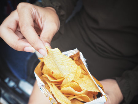 Woman eating potato chip