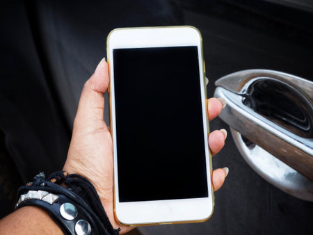 Smart phone on hand with car