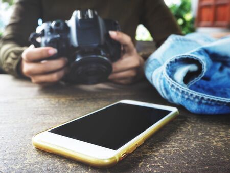 Woman using a camera with smart phoneの写真素材
