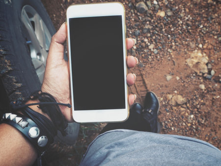 Woman using smart phone with car