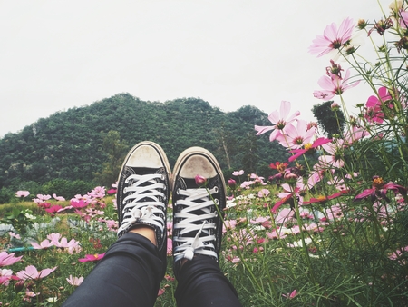 Selfie of sneakers with flowerの写真素材