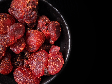 Dried strawberries on black backgroundの写真素材