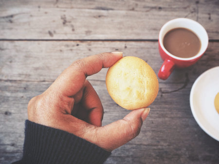 Woman eating cookie butter with coffee cup