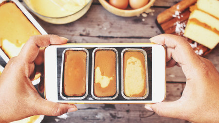 Taking a photo of butter cake and ingredients with smart phone