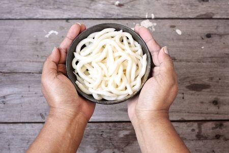 Udon noodle with hands Japanese foodの写真素材