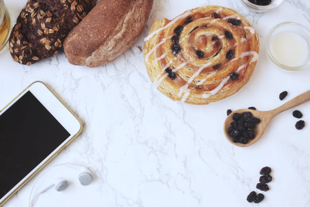 Smart phone and earphone with cinnamon rollの写真素材