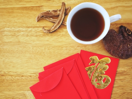 Red envelope chinese with ganoderma lucidum mushroom teaの写真素材