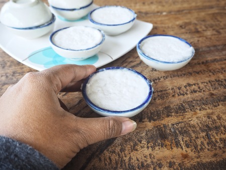 Coconut pudding dessert with handの写真素材