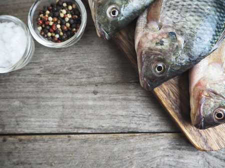 Fresh raw fish with salt and peppercorns