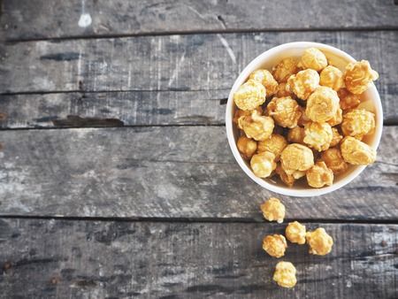 Popcorn caramel on wood backgroundの写真素材