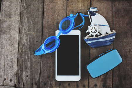 Bluetooth speaker and smart phone
 diving glasses ship travel concept